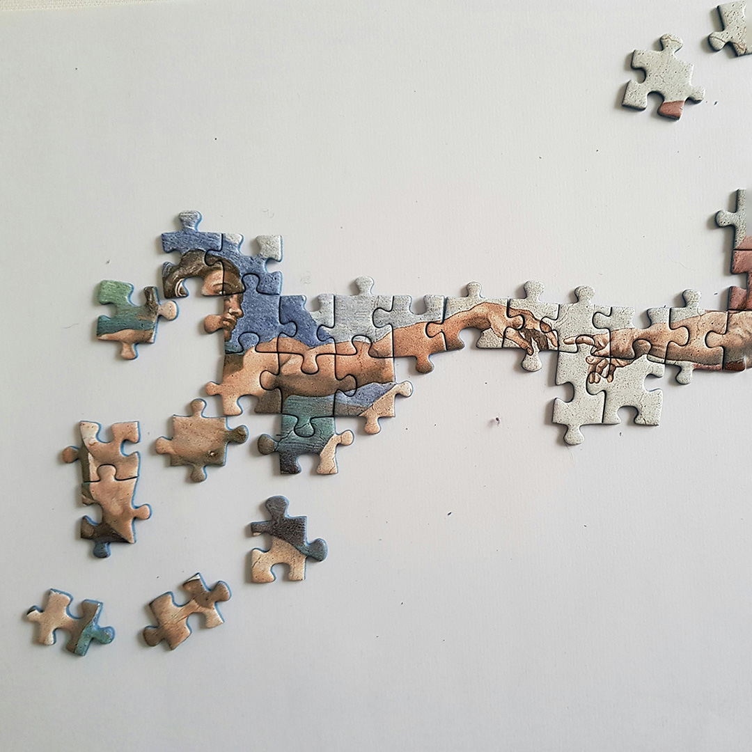 Puzzle przedstawiające fragment obrazu "Stworzenie Adama"